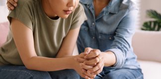 Middle aged asia people old mom holding hands trust comfort help young woman talk crying stress relief at home. Mum as friend love care hold hand adult child feel pain sad worry of life crisis issues.