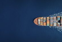 Aerial top down view of a large container cargo ship with copy space