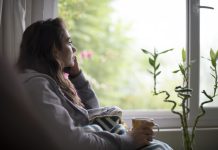 Depressed Woman Sitting by Window